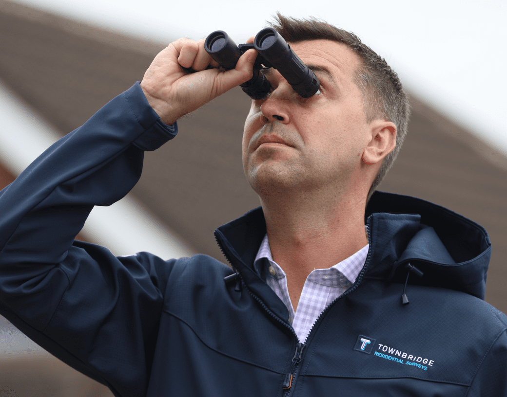Mark Surveys House with his Scope