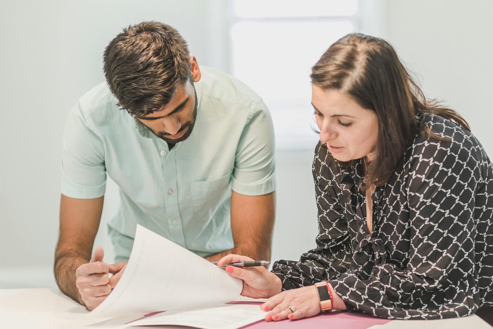Woman Signing and Reviewing Documents